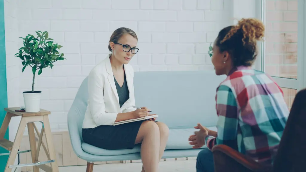 Therapist and client in a session, comparing Psychology Today vs therapist website options
