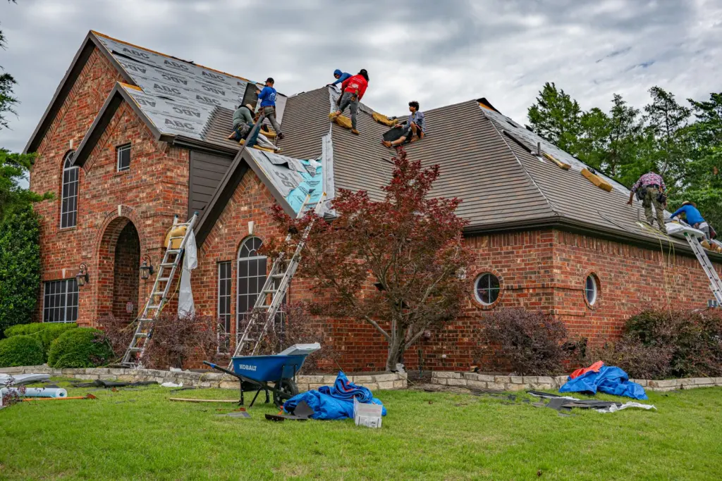 Roofers working on a house, the kind of local job featured on service area pages