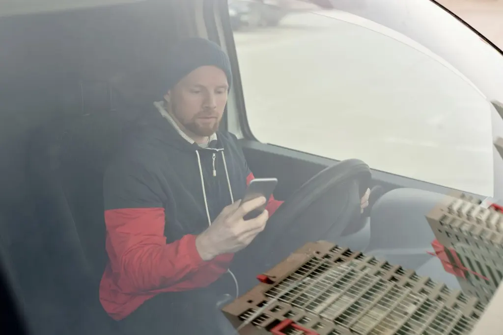 Tradesman in his van checking replies from missed call text back