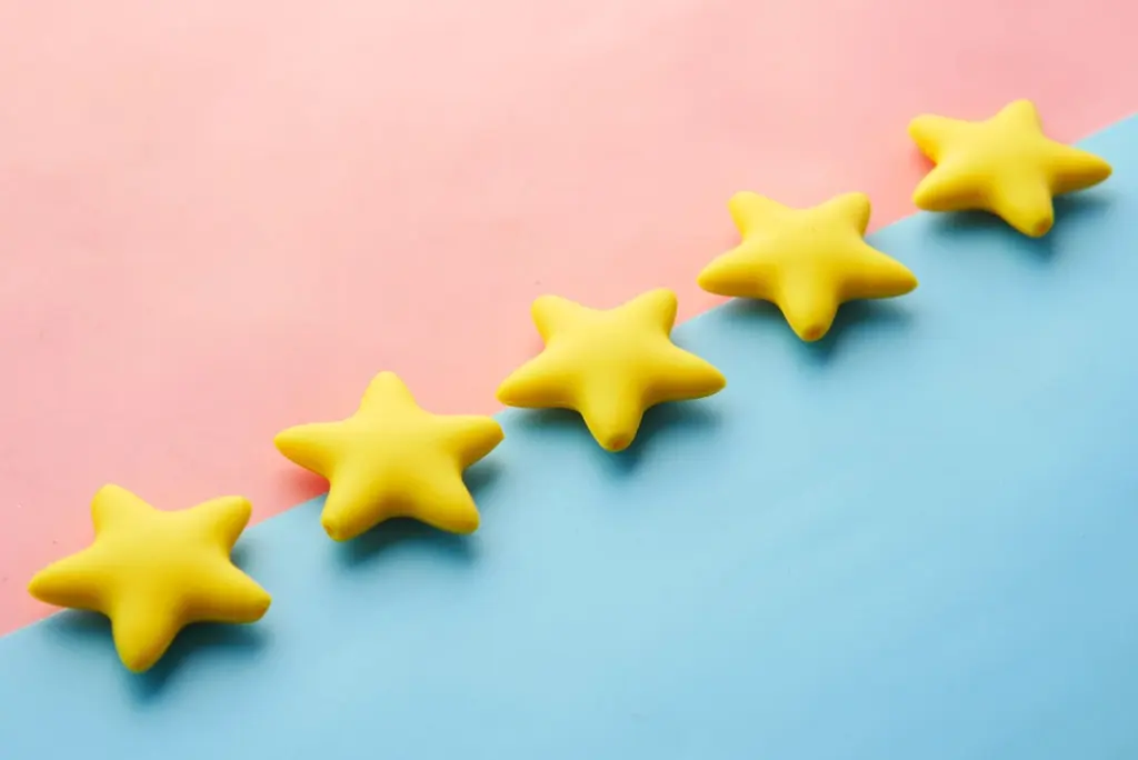 Five stars on a pastel background showing how to get more Google reviews